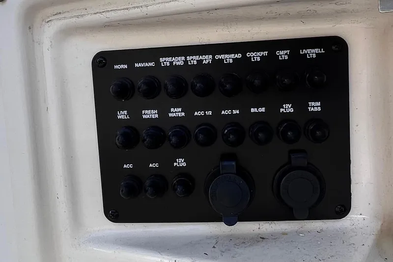 Slide: The Image of Control panel of a 2015 Pathfinder 2600 HPS boat with labeled switches and plugs. - 22