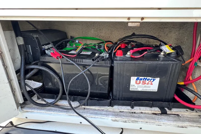 Slide: The Image of Battery compartment of a 2015 Pathfinder 2600 HPS with connected cables. - 23