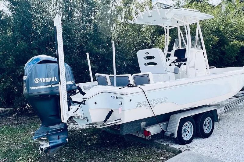 Slide: The Image of 2015 Pathfinder 2600 HPS boat on trailer with Yamaha outboard motor, parked outdoors. - 9