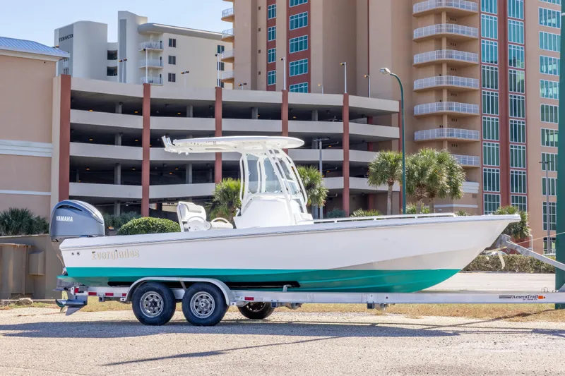 The Image of 2016 Everglades 243 Center Console boat on trailer, parked near a road. - 0