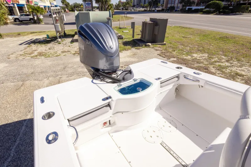 Slide: The Image of 2016 Everglades 243 Center Console boat, white interior, parked on gravel lot. - 10