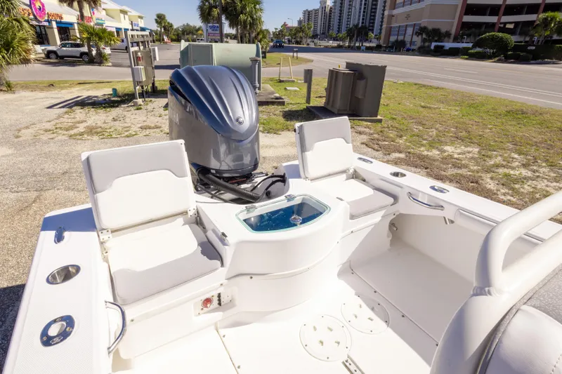 Slide: The Image of 2016 Everglades 243 Center Console boat, spacious deck view, parked on a sunny day. - 11