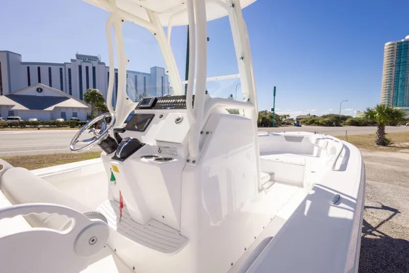 Slide: The Image of 2016 Everglades 243 Center Console boat with Yamaha outboard engine, parked outdoors. - 20
