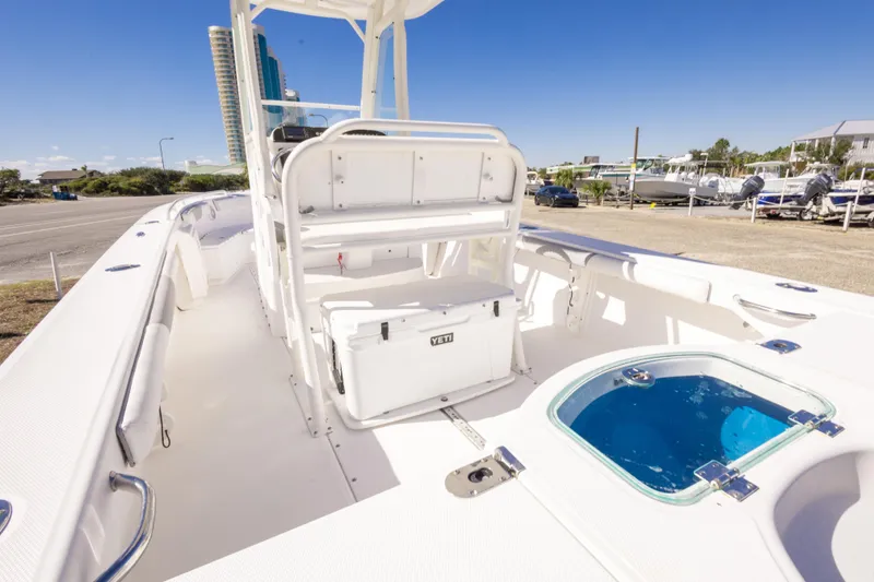 Slide: The Image of 2016 Everglades 243 Center Console boat interior with Yamaha engine, parked near a road. - 21