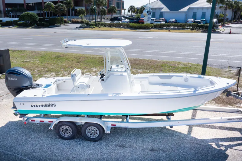 Slide: The Image of 2016 Everglades 243 Center Console boat at marina, clear sky, urban backdrop. - 24