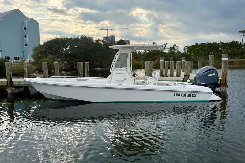 Slide: The Image of 2016 Everglades 243 Center Console boat docked on calm water, overcast sky. - 31