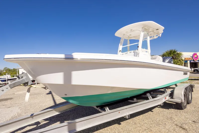 Slide: The Image of 2016 Everglades 243 Center Console boat with Yamaha engine on trailer, urban backdrop. - 4