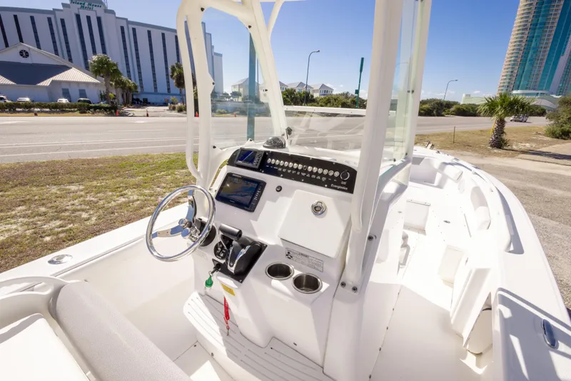 Slide: The Image of 2016 Everglades 243 Center Console boat with modern helm, urban backdrop. - 7