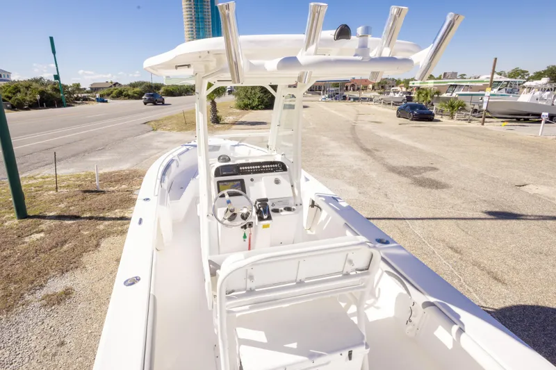 Slide: The Image of 2016 Everglades 243 Center Console boat with modern dashboard, parked near buildings. - 8