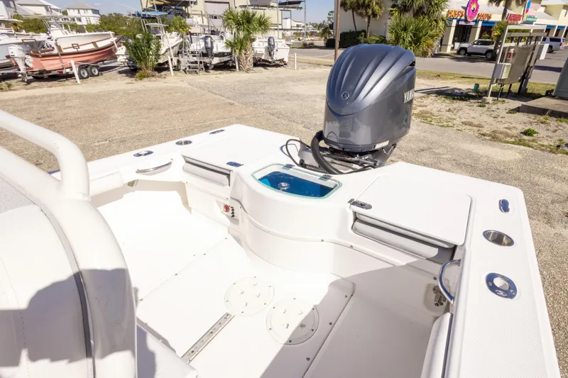 Slide: The Image of 2016 Everglades 243 Center Console boat parked near coastal buildings. - 9