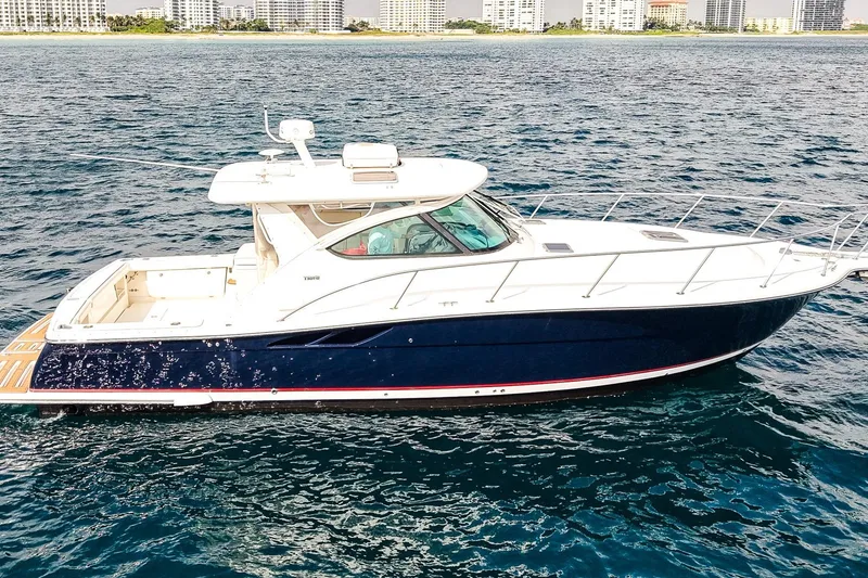 Slide: The Image of 2005 Tiara Yachts 3800 Open cruising on blue ocean near city skyline. - 1