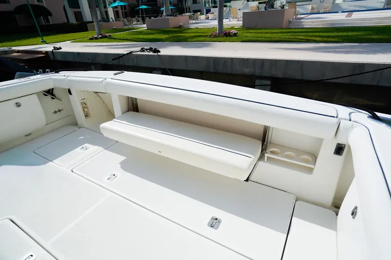 Slide: The Image of 2005 Tiara Yachts 3800 Open boat interior with white seating and storage compartments. - 13