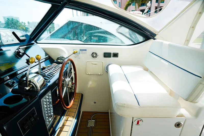 Slide: The Image of 2005 Tiara Yachts 3800 Open helm with steering wheel and controls. - 22