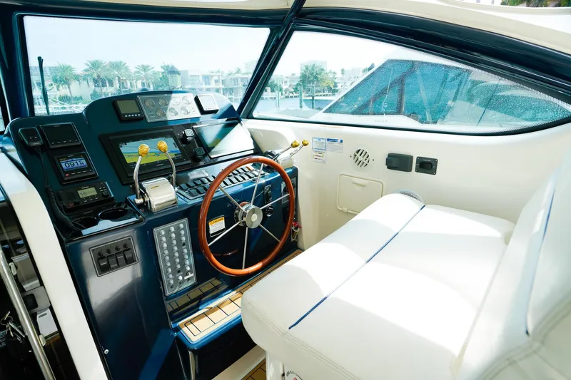 Slide: The Image of 2005 Tiara Yachts 3800 Open helm with modern controls and luxurious seating. - 23