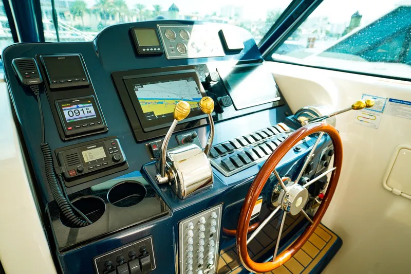 Slide: The Image of Helm of 2005 Tiara Yachts 3800 Open with navigation equipment and wooden steering wheel. - 24