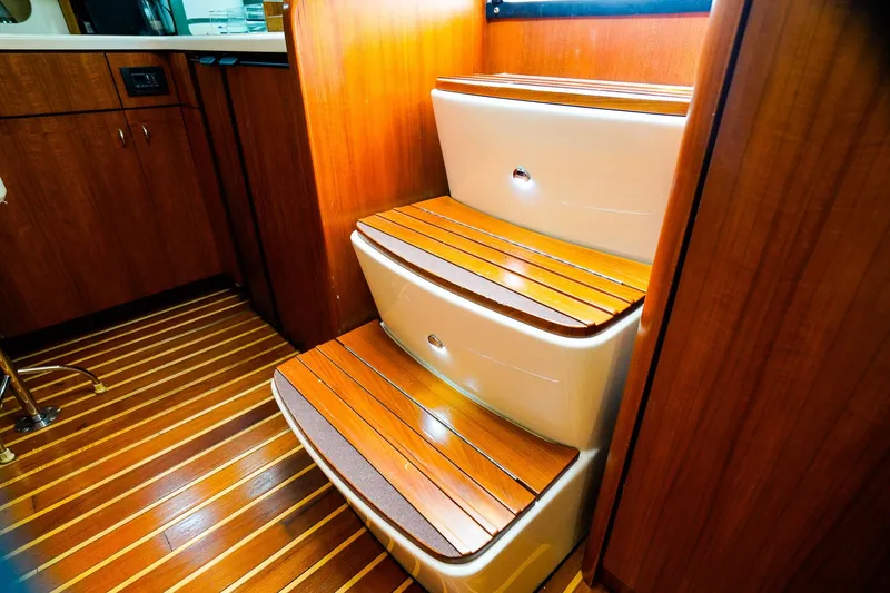 Slide: The Image of Interior of 2005 Tiara Yachts 3800 Open, featuring wooden steps and cabinetry. - 26
