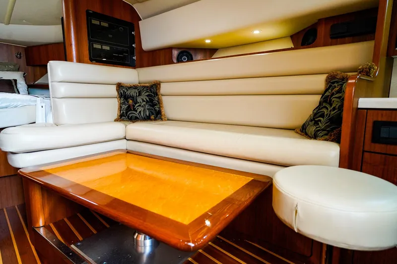 Slide: The Image of Luxurious interior of 2005 Tiara Yachts 3800 Open with leather seating and wooden table. - 28