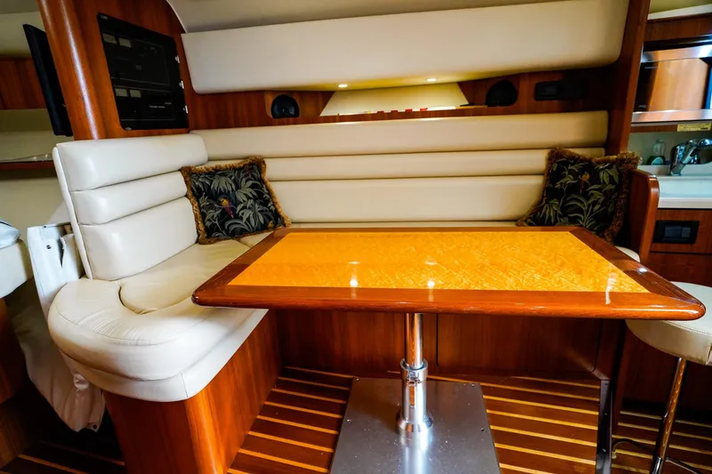 Slide: The Image of Luxurious interior of 2005 Tiara Yachts 3800 Open with elegant seating and wooden table. - 29