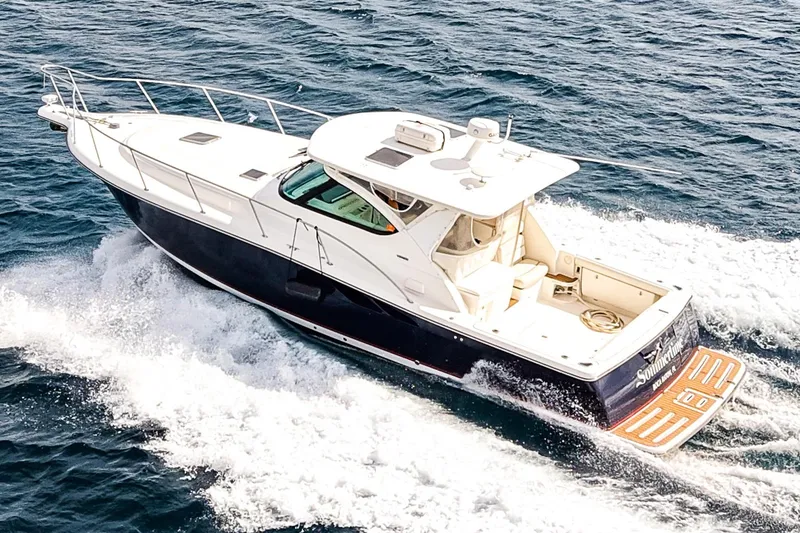 Slide: The Image of 2005 Tiara Yachts 3800 Open cruising on the ocean, showcasing sleek design and performance. - 3