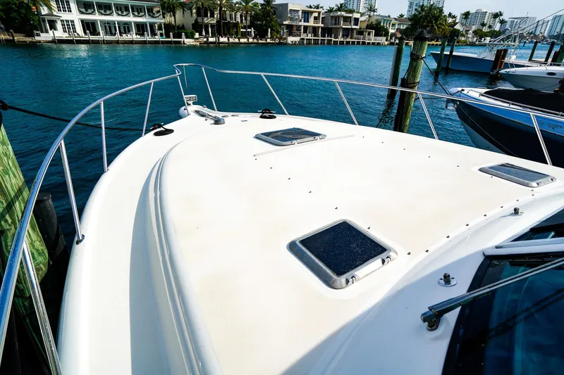 Slide: The Image of 2005 Tiara Yachts 3800 Open docked by waterfront homes. - 42