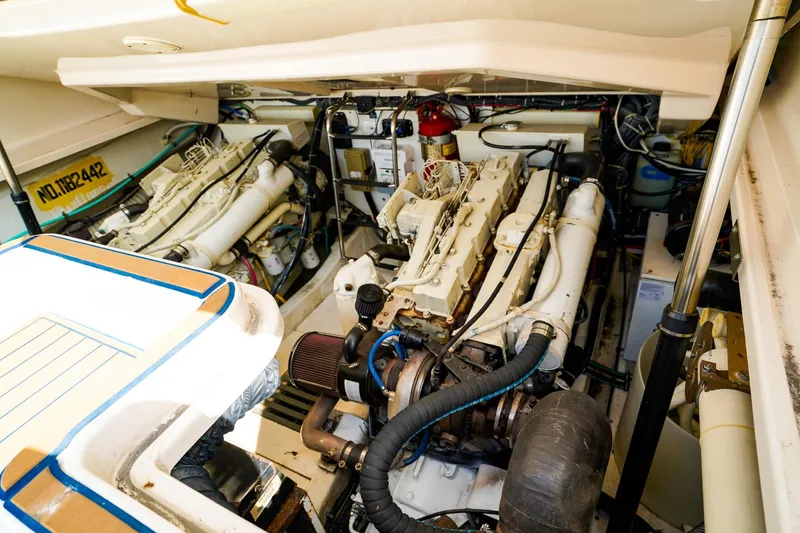 Slide: The Image of Engine compartment of a 2005 Tiara Yachts 3800 Open, showcasing dual engines and mechanical components. - 44
