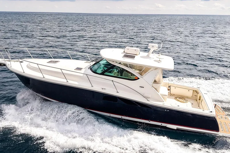 Slide: The Image of 2005 Tiara Yachts 3800 Open cruising on the ocean, showcasing sleek design and performance. - 5