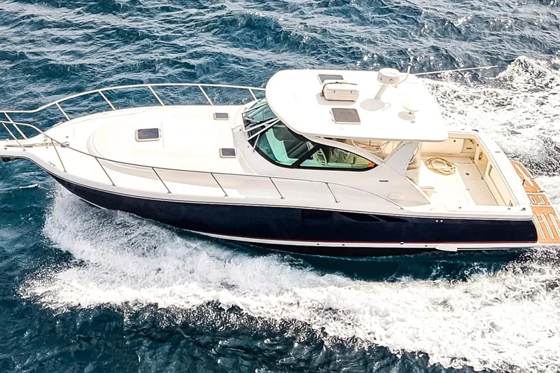 Slide: The Image of 2005 Tiara Yachts 3800 Open cruising on the ocean, showcasing sleek design and performance. - 7
