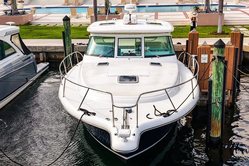 Slide: The Image of 2005 Tiara Yachts 3800 Open docked at marina, front view. - 9