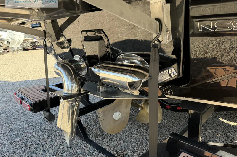 Slide: The Image of 2022 Nautique Super Air Nautique G23 propeller and rudder detail on gravel surface. - 10