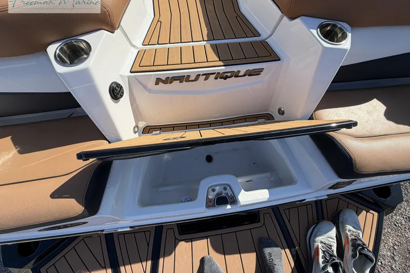 Slide: The Image of 2022 Nautique Super Air Nautique G23 boat interior with tan and white seating. - 17