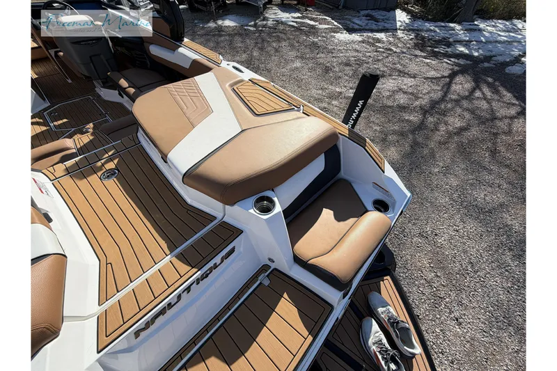 Slide: The Image of Luxurious interior of 2022 Nautique Super Air Nautique G23 boat with tan seating. - 19