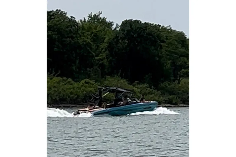 Slide: The Image of 2022 Nautique Super Air Nautique G23 boat with sparkling blue exterior. - 2