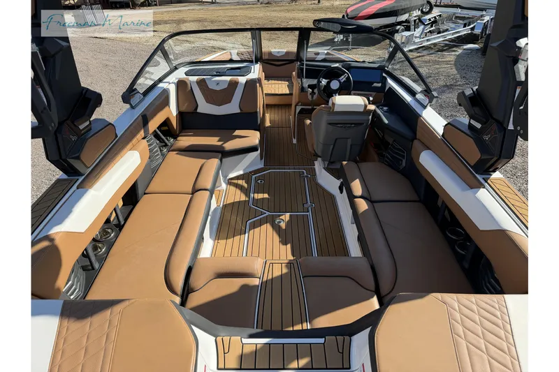 Slide: The Image of 2022 Nautique Super Air Nautique G23 interior with tan and white seating, teak flooring. - 20