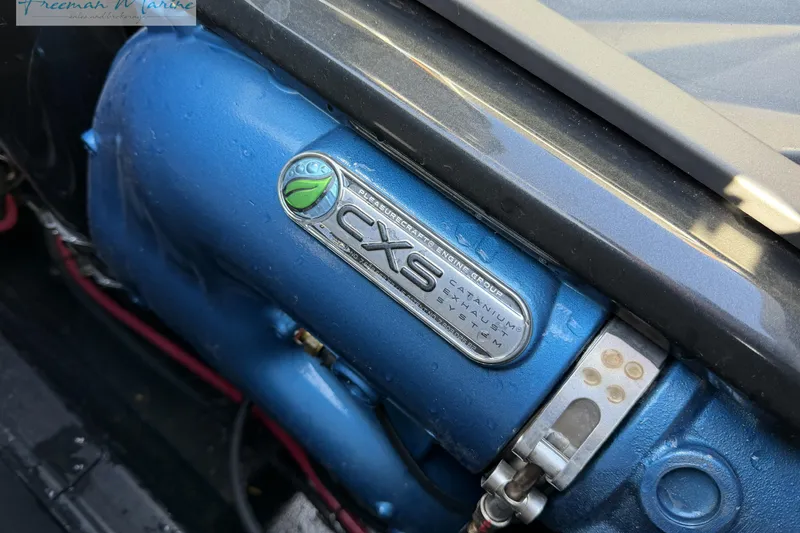 Slide: The Image of 2022 Nautique Super Air Nautique G23 engine compartment with filter and valve components. - 30