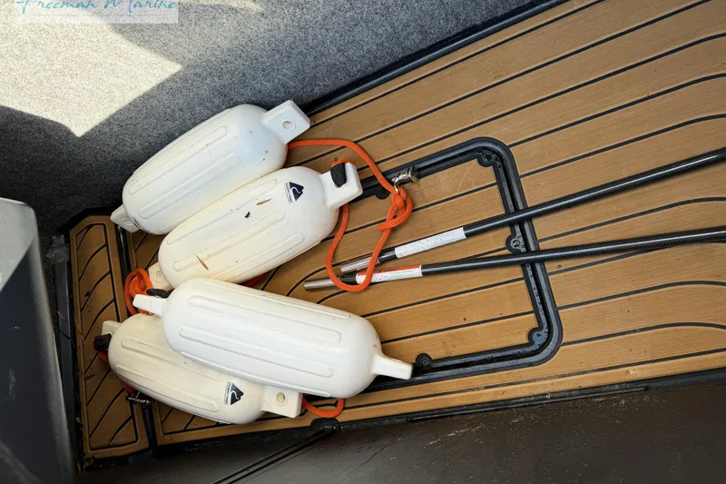 Slide: The Image of 2022 Nautique Super Air Nautique G23 interior with tan and black seating. - 34