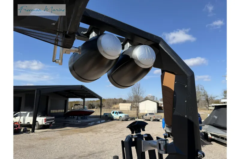 Slide: The Image of 2022 Nautique Super Air Nautique G23 boat speakers and tower in a marina setting. - 38