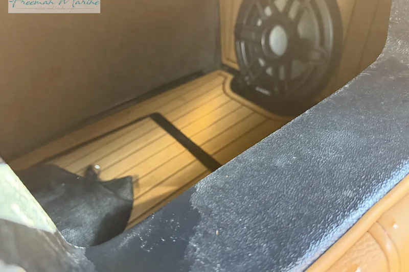 Slide: The Image of 2022 Nautique Super Air Nautique G23 interior with black cover and fire extinguisher. - 49