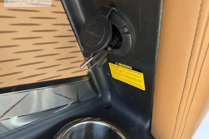 Slide: The Image of 2022 Nautique Super Air Nautique G23 boat interior with tan leather seating and wood flooring. - 52