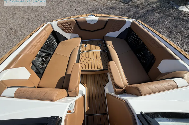 Slide: The Image of 2022 Nautique Super Air Nautique G23 interior with tan upholstery and wood accents. - 53