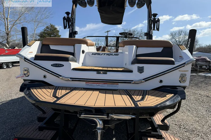 Slide: The Image of 2022 Nautique Super Air Nautique G23 boat with teak deck and cushioned seating. - 8