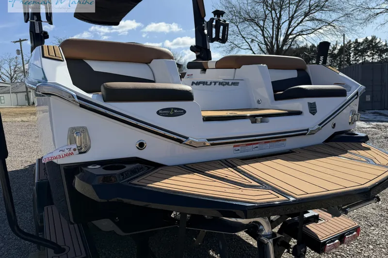 Slide: The Image of 2022 Nautique Super Air Nautique G23 boat stern with propeller and exhaust system. - 9