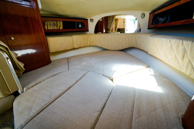 Slide: The Image of Interior cabin of 2007 Sea Ray 280 Sundancer with beige upholstery and wood accents. - 22