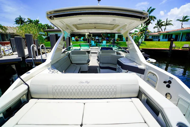 Slide: The Image of 2022 Sea Ray SLX 310 OB luxury boat with spacious seating and elegant design. - 10