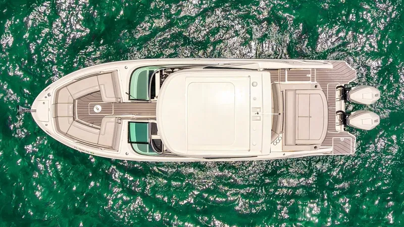 Slide: The Image of Top view of 2022 Sea Ray SLX 310 Outboard on vibrant green water. - 4