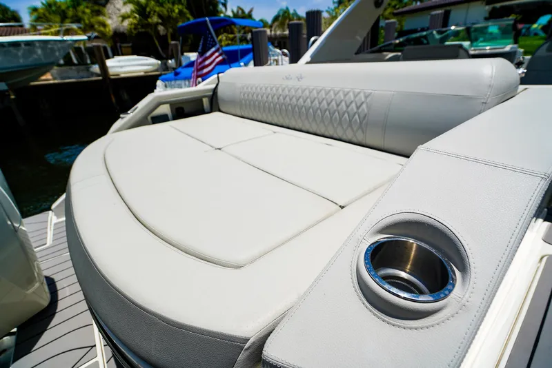 Slide: The Image of 2022 Sea Ray SLX 310 OB boat with luxurious seating and cup holder. - 7
