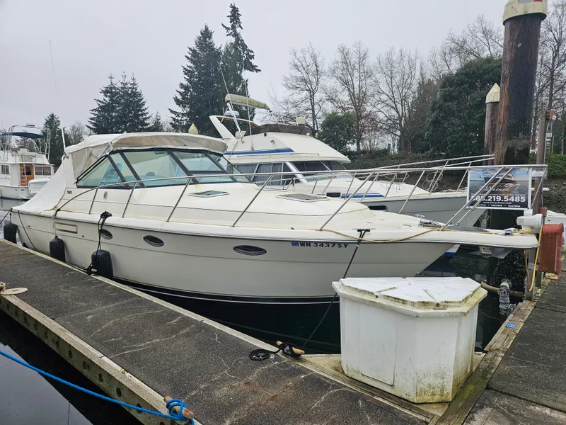The Image of 1996 Tiara Yachts 3100 EXPRESS docked, featuring sleek design and spacious deck. - 0