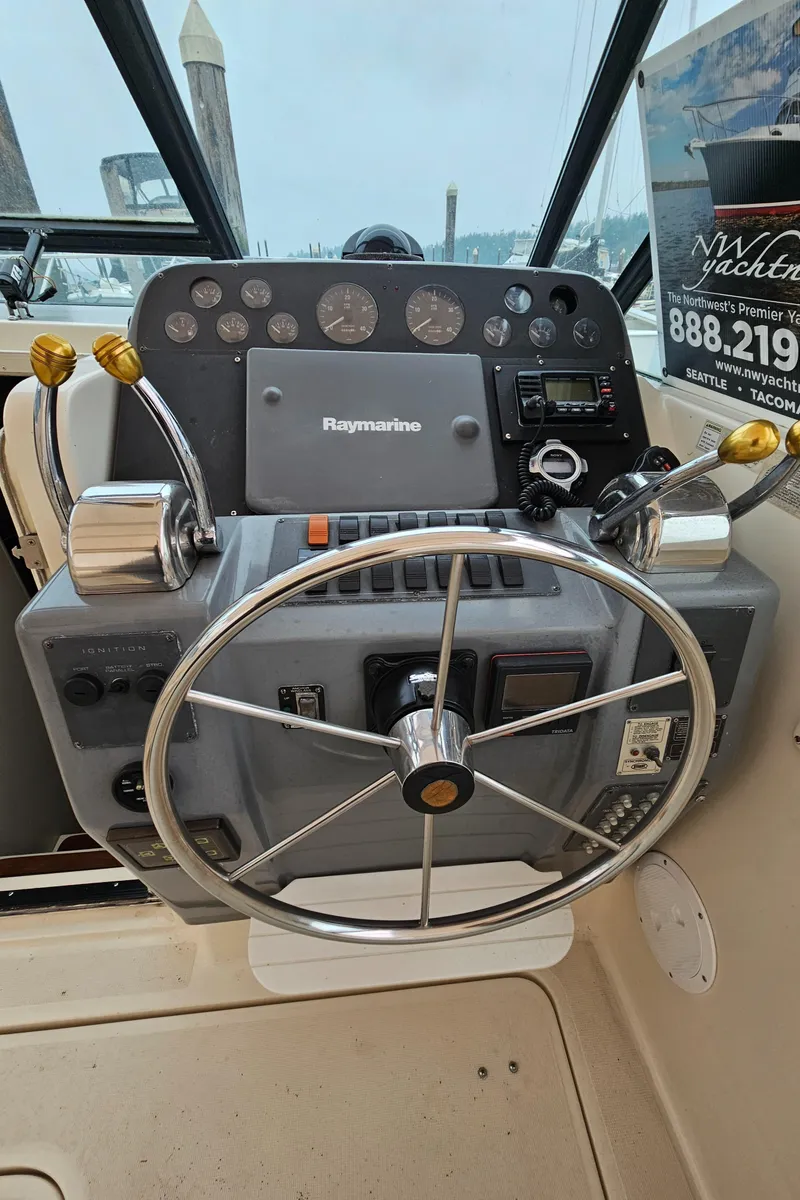 Slide: The Image of 1996 Tiara Yachts 3100 EXPRESS helm with steering wheel and control panel. - 10