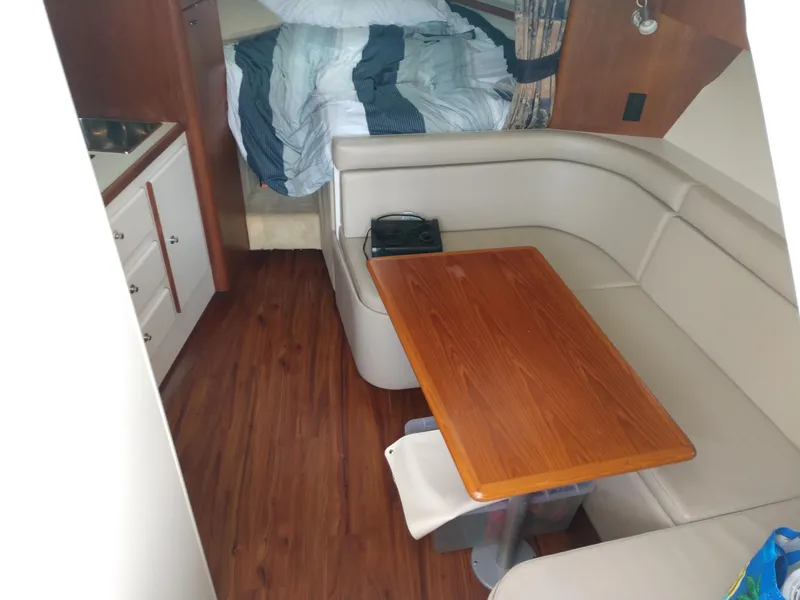Slide: The Image of 1996 Tiara Yachts 3100 EXPRESS interior with dining area and bed. - 14