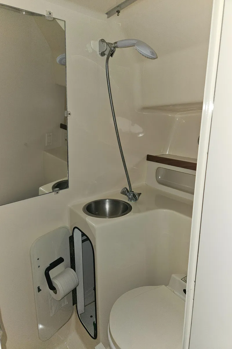 Slide: The Image of 1996 Tiara Yachts 3100 EXPRESS bathroom with shower, sink, and toilet. - 17
