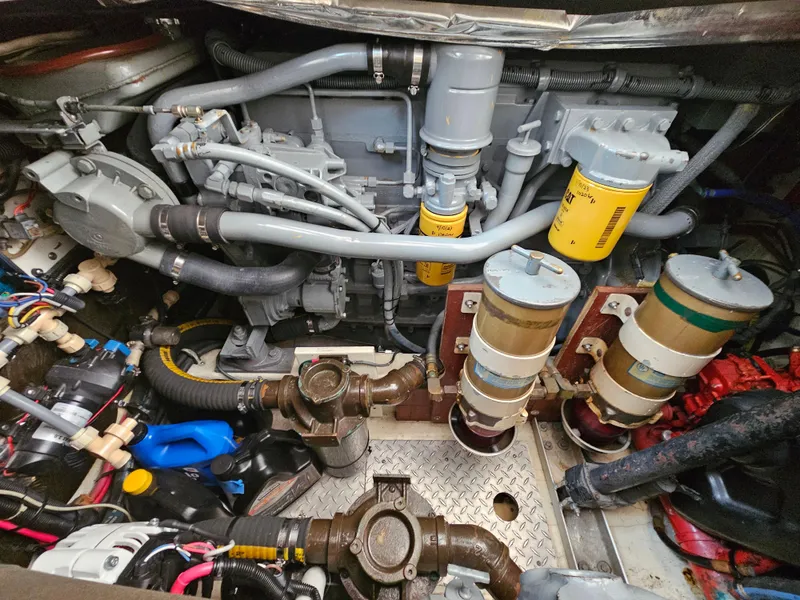 Slide: The Image of Engine compartment of a 1996 Tiara Yachts 3100 EXPRESS, showcasing mechanical components and filters. - 24